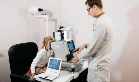 A professional optometrist examines a child's eyes using advanced equipment.