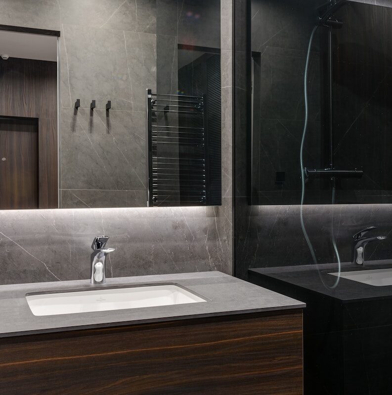 Stylish bathroom with glass elements in apartment