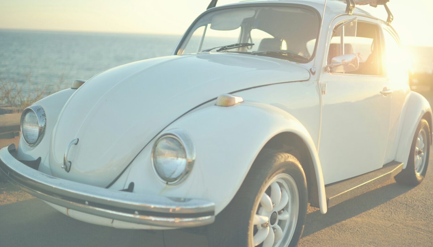 white Volkswagen Beetle on road at daytime
