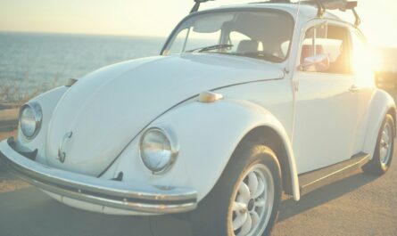 white Volkswagen Beetle on road at daytime
