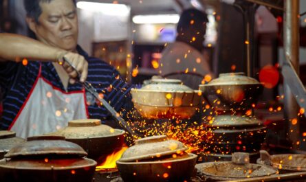 man holding tongs while cooking