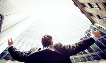 low-angle photography of man in the middle of buidligns